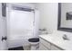 Clean bathroom with tiled shower and tub, a vanity and a bright-colored sink at 8221 W Hess Ave, Phoenix, AZ 85043