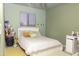 This bedroom features a light-colored walls and a large window for natural light at 8221 W Hess Ave, Phoenix, AZ 85043