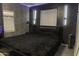 Dark themed bedroom with sleek bed frame and modern lighting fixtures offers unique design at 8221 W Hess Ave, Phoenix, AZ 85043