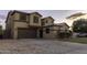 A two-story home features a 2-car garage, desert landscaping, and a concrete driveway at 8221 W Hess Ave, Phoenix, AZ 85043