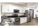 Bright kitchen with stainless steel appliances, white cabinets, and ample counter space at 8221 W Hess Ave, Phoenix, AZ 85043
