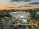 Aerial view of a modern home with a spacious yard featuring a pool, spa, lounge area, putting green, and outdoor kitchen at 8245 E Via Del Sol Dr, Scottsdale, AZ 85255