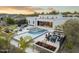 This aerial view features a modern home with a large backyard pool, spa, outdoor kitchen and lounge area at 8245 E Via Del Sol Dr, Scottsdale, AZ 85255