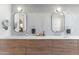 Bathroom vanity with double sinks, wooden cabinets and modern light fixtures at 8245 E Via Del Sol Dr, Scottsdale, AZ 85255