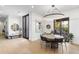 Bright dining room with round table, modern lighting fixture, and large bee artwork at 8245 E Via Del Sol Dr, Scottsdale, AZ 85255