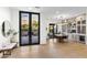 Bright dining area with large windows, a modern chandelier, and a built-in bar area, perfect for entertaining guests at 8245 E Via Del Sol Dr, Scottsdale, AZ 85255