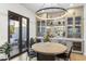 Dining room with round table, view to the patio, and built-in bar with glass-front cabinets at 8245 E Via Del Sol Dr, Scottsdale, AZ 85255