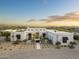 Stunning modern home featuring desert landscaping, a grand entrance, and a spacious driveway, offering curb appeal at 8245 E Via Del Sol Dr, Scottsdale, AZ 85255