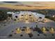 Elegant modern home with desert landscaping, sophisticated lighting, and a private driveway, creating a welcoming ambiance at 8245 E Via Del Sol Dr, Scottsdale, AZ 85255