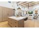 Modern kitchen featuring a large island, wooden cabinets, and open layout to the living area at 8245 E Via Del Sol Dr, Scottsdale, AZ 85255