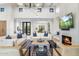 Inviting living room featuring high ceilings, a modern fireplace with TV, and comfortable seating for relaxation at 8245 E Via Del Sol Dr, Scottsdale, AZ 85255