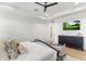 Comfortable main bedroom features a ceiling fan and mounted television at 8245 E Via Del Sol Dr, Scottsdale, AZ 85255