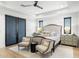 Well-lit main bedroom boasts a tray ceiling, ceiling fan and cozy seating area at 8245 E Via Del Sol Dr, Scottsdale, AZ 85255