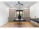 Bright office with built-in cabinets, ample counter space and a modern ceiling fan at 8245 E Via Del Sol Dr, Scottsdale, AZ 85255