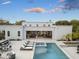 Beautiful outdoor pool with lounge chairs, jacuzzi, and covered patio with views into the home at 8245 E Via Del Sol Dr, Scottsdale, AZ 85255