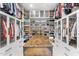 Spacious walk-in closet with custom shelving and a central island at 8245 E Via Del Sol Dr, Scottsdale, AZ 85255