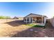 Backyard featuring gravel, turf, covered patio, table and chairs and a block fence at 8576 E Jasper St, Gold Canyon, AZ 85118