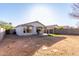 Backyard featuring gravel, turf, covered patio, grill and a block fence at 8576 E Jasper St, Gold Canyon, AZ 85118