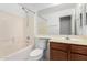 Neutral bathroom featuring a combination shower and tub, toilet and vanity with wooden cabinets at 8576 E Jasper St, Gold Canyon, AZ 85118