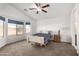 Bright bedroom featuring a ceiling fan, bay windows, and neutral carpet, offering a comfortable and serene living space at 8576 E Jasper St, Gold Canyon, AZ 85118