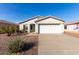 Charming single-story home featuring a two-car garage, landscaped front yard and neutral color palette at 8576 E Jasper St, Gold Canyon, AZ 85118