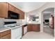 Functional kitchen with neutral countertops, wooden cabinets, and standard appliances, perfect for everyday meals at 8576 E Jasper St, Gold Canyon, AZ 85118