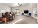 Inviting living room with a ceiling fan, neutral colors, and sliding glass doors to the patio at 8576 E Jasper St, Gold Canyon, AZ 85118