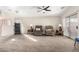 Comfortable living room featuring neutral carpeting, a ceiling fan, and sliding glass doors at 8576 E Jasper St, Gold Canyon, AZ 85118