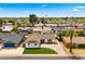Well maintained home with vibrant green lawn and an expansive driveway in quiet neighborhood at 8631 E Jackrabbit Rd, Scottsdale, AZ 85250