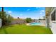 Backyard featuring a pool, lush landscaping, and privacy fence at 8631 E Jackrabbit Rd, Scottsdale, AZ 85250