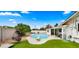 Backyard with a pool, lounge chairs, and well-manicured landscaping at 8631 E Jackrabbit Rd, Scottsdale, AZ 85250