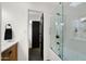 Modern bathroom featuring subway tile, glass shower doors, and dark fixtures at 8631 E Jackrabbit Rd, Scottsdale, AZ 85250