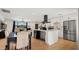 Stylish, open-concept kitchen featuring white cabinets, stainless appliances, and an adjacent dining area at 8631 E Jackrabbit Rd, Scottsdale, AZ 85250
