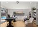 A well-lit office with white walls, wood floors, and built-in shelves, creating a clean and functional workspace at 8631 E Jackrabbit Rd, Scottsdale, AZ 85250