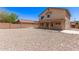 Spacious backyard featuring gravel, rear home elevation, and concrete patio at 906 S 242Nd Dr, Buckeye, AZ 85326
