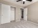 Bedroom with carpet, neutral walls, ceiling fan, and closet in this simple yet comfortable design at 906 S 242Nd Dr, Buckeye, AZ 85326