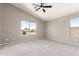 A bedroom boasts a vaulted ceiling, soft carpet, and a large window that brings in natural light at 906 S 242Nd Dr, Buckeye, AZ 85326