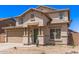 Two-story home featuring desert landscaping, a green front door, and a two-car garage at 906 S 242Nd Dr, Buckeye, AZ 85326