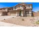 Two-story home featuring desert landscaping, a green front door, and a two-car garage at 906 S 242Nd Dr, Buckeye, AZ 85326