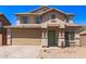 Two-story home featuring desert landscaping, a two car garage, and a covered front entry way at 906 S 242Nd Dr, Buckeye, AZ 85326