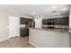 This kitchen has stainless steel appliances and dark cabinets with neutral countertops at 906 S 242Nd Dr, Buckeye, AZ 85326