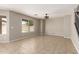 Inviting living room with tile flooring, ceiling fan, and ample natural light at 906 S 242Nd Dr, Buckeye, AZ 85326