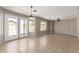 This spacious living area is filled with natural light from the windows and glass doors at 906 S 242Nd Dr, Buckeye, AZ 85326