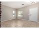 Open living room featuring neutral paint, tile flooring, and natural light at 906 S 242Nd Dr, Buckeye, AZ 85326