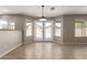 Open living room with tile flooring, modern lighting, and views to the backyard at 906 S 242Nd Dr, Buckeye, AZ 85326