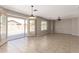 Bright living room with tile floors, modern light fixtures, and access to the backyard at 906 S 242Nd Dr, Buckeye, AZ 85326
