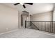 Upstairs loft area featuring soft carpet, iron banister, and neutral paint at 906 S 242Nd Dr, Buckeye, AZ 85326