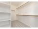 Spacious walk-in closet featuring shelving and carpet for storage at 906 S 242Nd Dr, Buckeye, AZ 85326