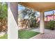 Covered back patio with a low wall and desert landscaping at 935 E Redondo Dr, Gilbert, AZ 85296