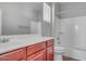 Bathroom featuring a wood vanity, sink, toilet, and a shower-tub combo at 935 E Redondo Dr, Gilbert, AZ 85296